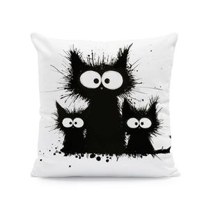 Detail shot of the white pillow cover featuring quirky hand-drawn black cat prints