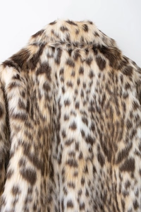 Detailed close-up showing the leopard print texture and soft fur of the fashion jacket