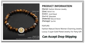 Detail view of tiger eye stone bead bracelet with a round stainless steel medallion charm