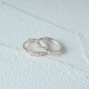 Detailed macro view of S925 sterling silver geometric hoop earrings with clear crystals