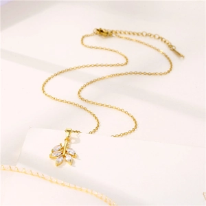Minimalist 18K gold leaf necklace with micro-pave marquise zirconia on white background