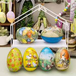 Easter tin egg candy boxes with bunny and chick patterns on a white metal display rack
