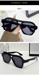 Close-up of black aviator sunglasses with double bridge frame and dark grey lenses