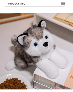 Close-up of fluffy husky plush toy with blue eyes and soft grey fur on a desk