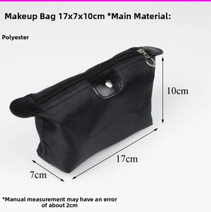 Detailed view of black polyester cosmetic bag with flap and metal snap, size 17x7x10cm