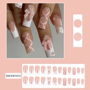 Pink and white 3D press-on nails with camellia flowers, bows and pearl accents