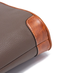 Detailed view of grey and tan lychee pattern leather textures with contrast stitching