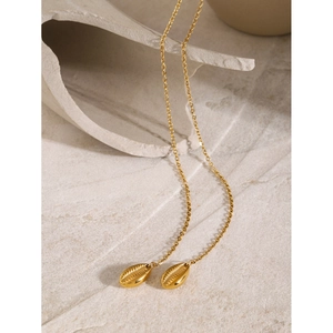 Detail of 18k gold double chain necklace featuring elegant shell pendants on stone