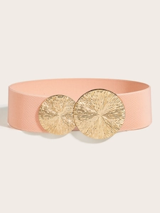 Detail of pink elastic waist belt featuring golden sunburst texture metal buckle