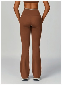 Macro detail of high-waist flared yoga pants in dark brown with seamless stitching