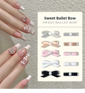 Detailed close-up of 3D ballet bow nail charms with central pearl in five metallic colors