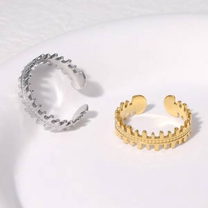 Detailed top view of gold and silver stainless steel open rings with serrated texture