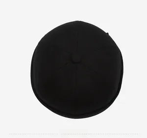 Top down view of black docker hat showing six-panel stitching and button detail