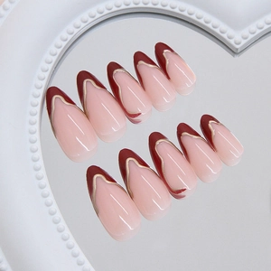 French press-on nails in nude pink and deep red with irregular golden metallic details