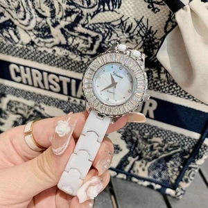 Close-up of white ceramic watch with crystal bezel and mother of pearl dial detail