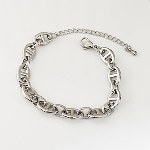 Close-up of silver pig nose chain links with adjustable lobster clasp and drop charm