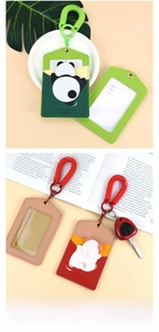 Detail view of cartoon panda and pig PU leather card holders with spring lanyards