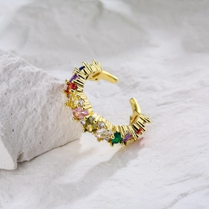 18K gold plated copper ring with colorful zircons on white stone background