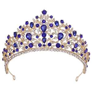 Close-up of golden bridal crown featuring elegant blue gemstones and small white diamonds
