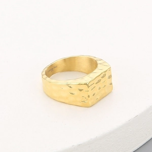 Detailed view of wide gold titanium steel ring featuring a hammered texture surface