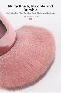 Macro detail of soft pink fiber bristles on a premium blush and powder makeup brush