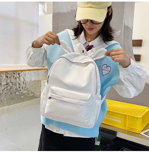 Side view of white canvas backpack with rabbit ears design worn by a female model