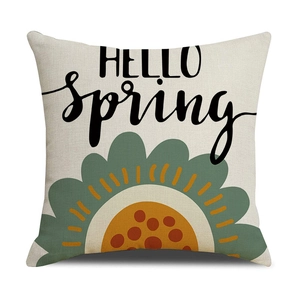 Close-up of linen pillow cover with Hello Spring text and colorful floral patterns
