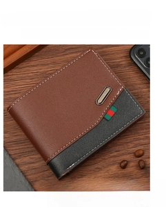 Detailed view of bifold leather wallet with color-block design and metallic logo plate