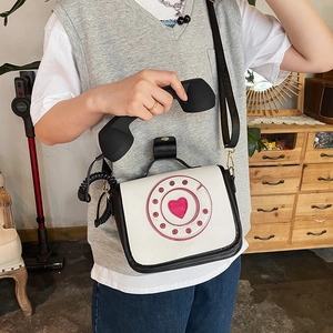 Vintage retro telephone style crossbody bag with heart dial design shown on a model