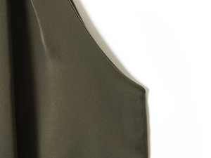 Close-up of olive green twill fabric with detailed stitching and high-quality texture