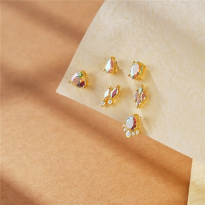 Detailed set of five gold plated cartilage earrings with moonstones and crystals