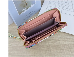 Detailed interior of a long zipper wallet showing multiple card slots and floral print