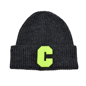 Detailed view of the ribbed knit texture and neon yellow letter C patch on a grey beanie