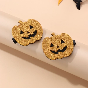 Detail of glittery gold pumpkin hair clips with black felt base for Halloween party wear