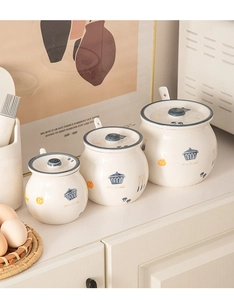 Three ceramic seasoning jars with lids and spoons featuring blue trim and love to eat text