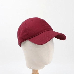 Detailed view of a burgundy cotton baseball cap featuring high-quality twill fabric texture