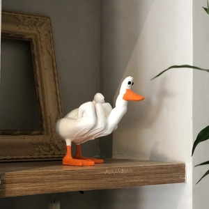 Detailed view of creative resin duck figurine with middle finger gesture for desk decor