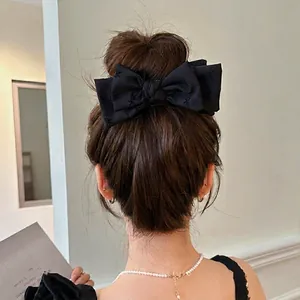 Elegant black double-layered butterfly print hair claw clip for a French ponytail style