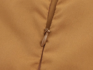 Detail view of the high-quality invisible zipper on a khaki sleeveless embroidered dress