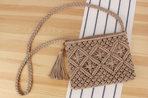 Detailed macro view of woven diamond pattern and tassel on bohemian macrame beach bag