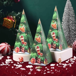 Green pyramid Christmas candy gift boxes with festive reindeer and bell illustrations