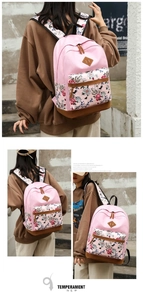 Detail of floral butterfly print backpack featuring pink canvas and brown leather zipper pull