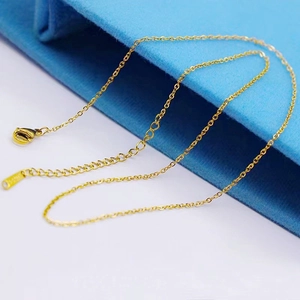 Detail of gold titanium steel curb chain necklace with secure lobster clasp and extender