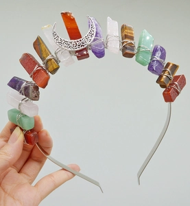 Detail of bohemian crown headband with colorful raw crystals and silver crescent moon