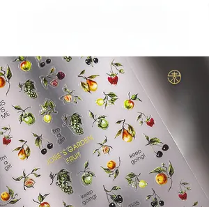 Macro shot of 5D embossed fruit nail stickers with vintage peach and grape patterns