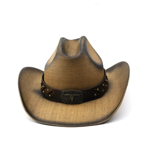 Detail of woven straw cowboy hat featuring vintage bull skull buckle and metal studs