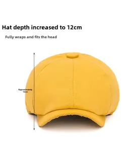 Detailed view of yellow newsboy cap with 12cm depth measurement and cotton texture