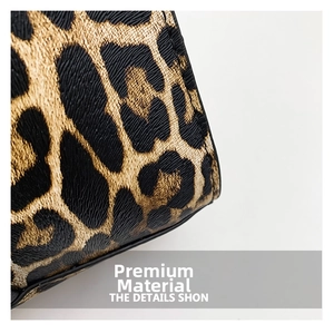 Close-up of leopard print handbag with high-quality textured leather and black piping detail