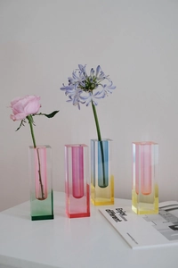 Close-up of modern rectangular acrylic vases with vibrant translucent gradient colors
