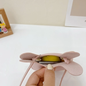 Close-up of pink bunny coin purse interior showing storage capacity and soft lining